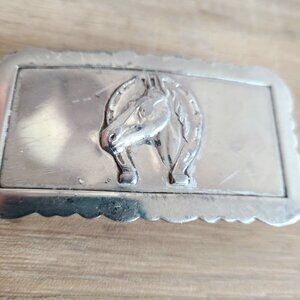 Silver color metal belt buckle with horse design. Western outfit.